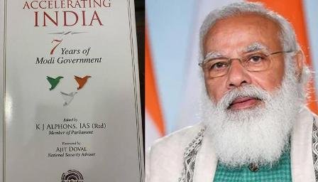 Former Union Minister K J Alphons presents his book 'Accelerating India: 7 Years of Modi Government' to PM Modi